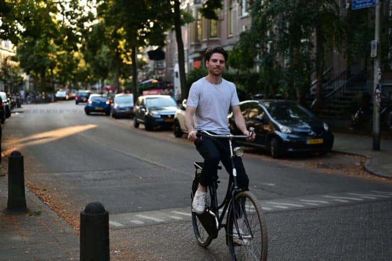 A boy cycles through Amsterdam