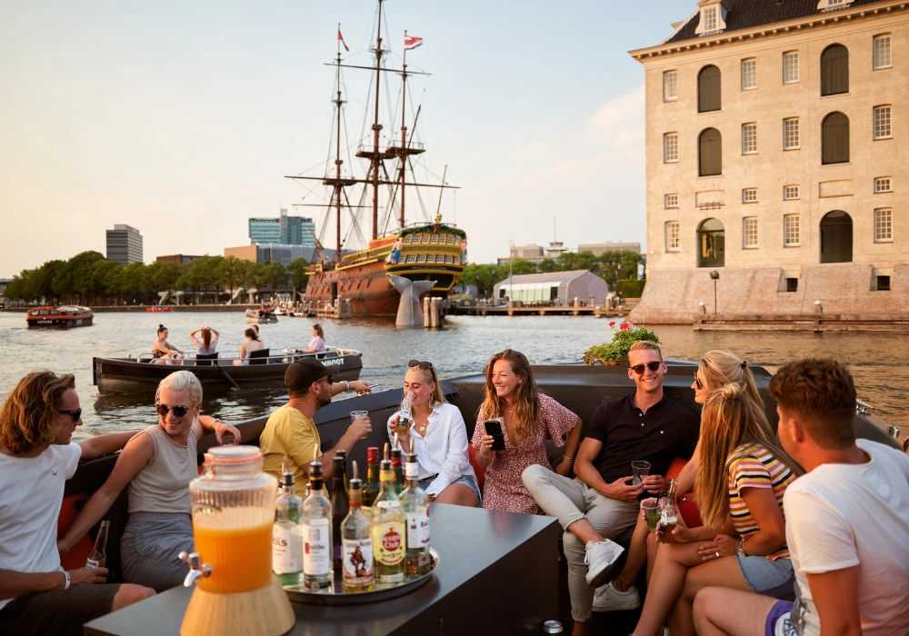 Group of people on a boat in Amsterdam at sunset