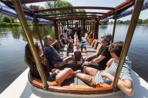 Company enjoying sun on aft deck boat MS Agatha