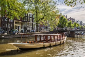 MS Agatha saloon boat sailing through Amsterdam canals