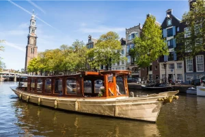 MS Agatha saloon boat sailing past Westerkerk Amsterdam