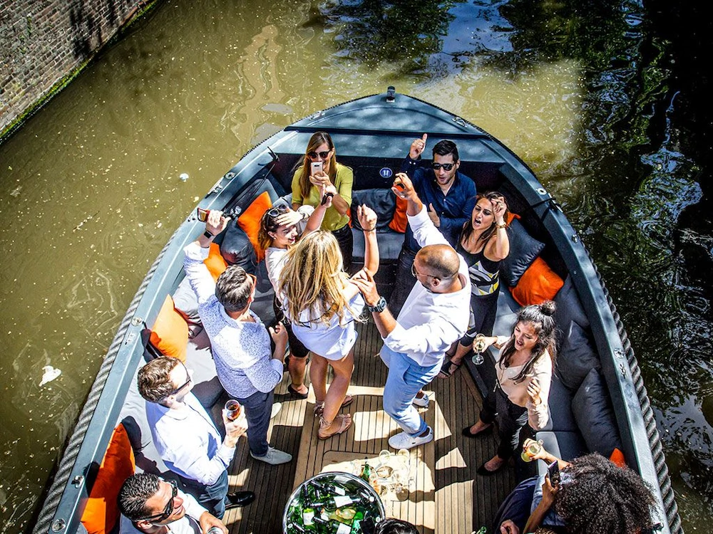 Group of people partying on a sloop on the water