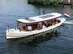 Side view of the Griffioen saloon boat with the captain