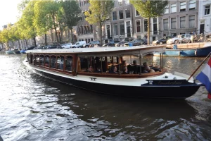 The Monne de Marinde saloon boat sailing through the canals of Amsterdam