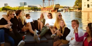 A boat with people chatting in Amsterdam