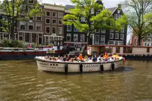 Nomag sloop with skipper and group on the canals of Amsterdam