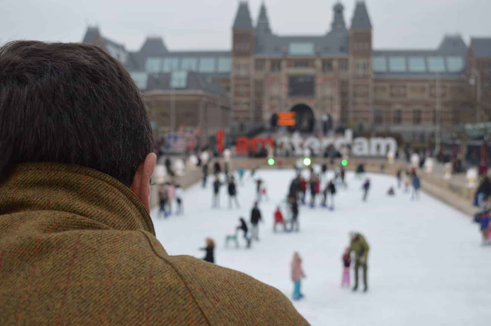 Man watches skaters at Museumplein in Amsterdam